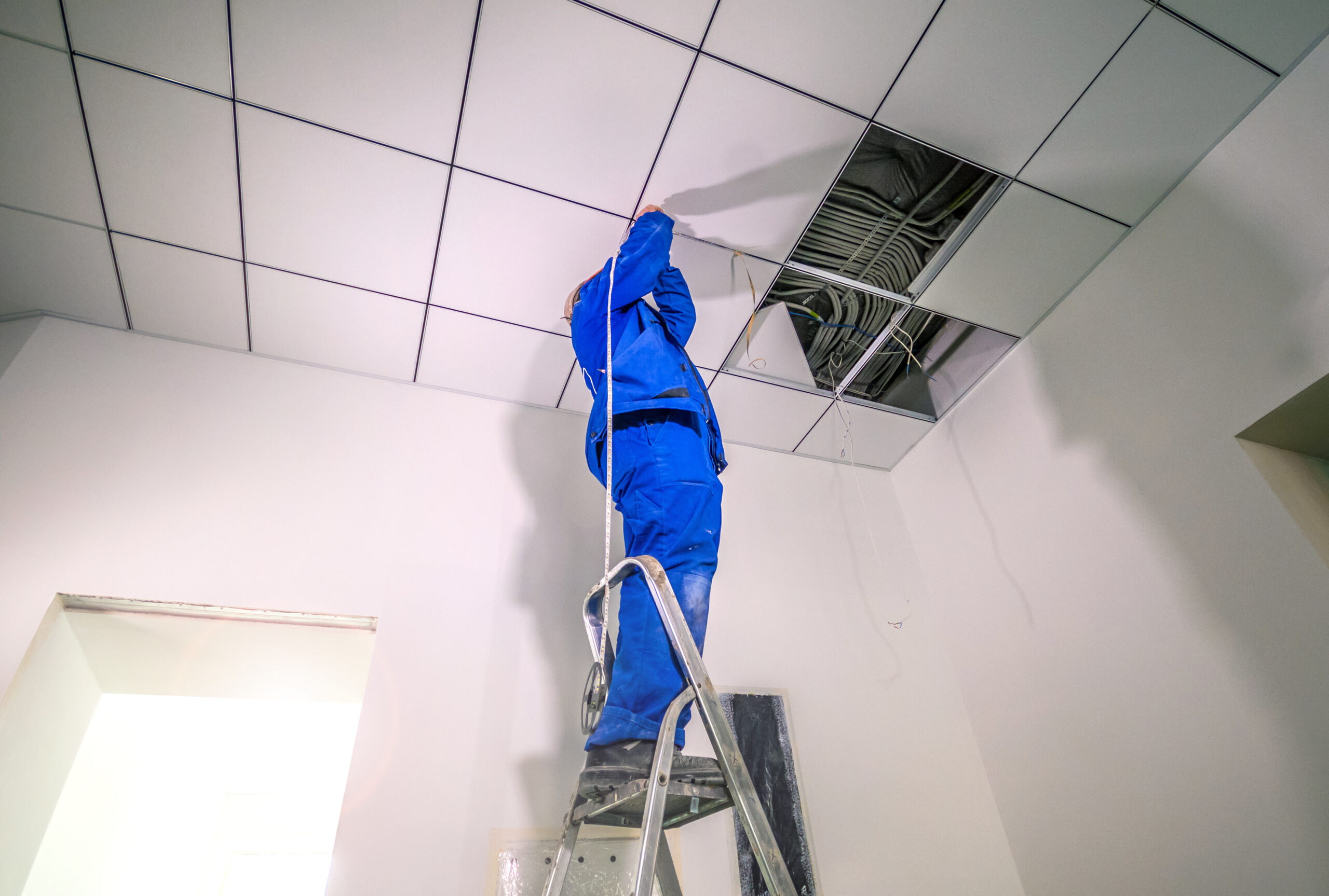 ABS/CBS worker performing commercial building maintenance